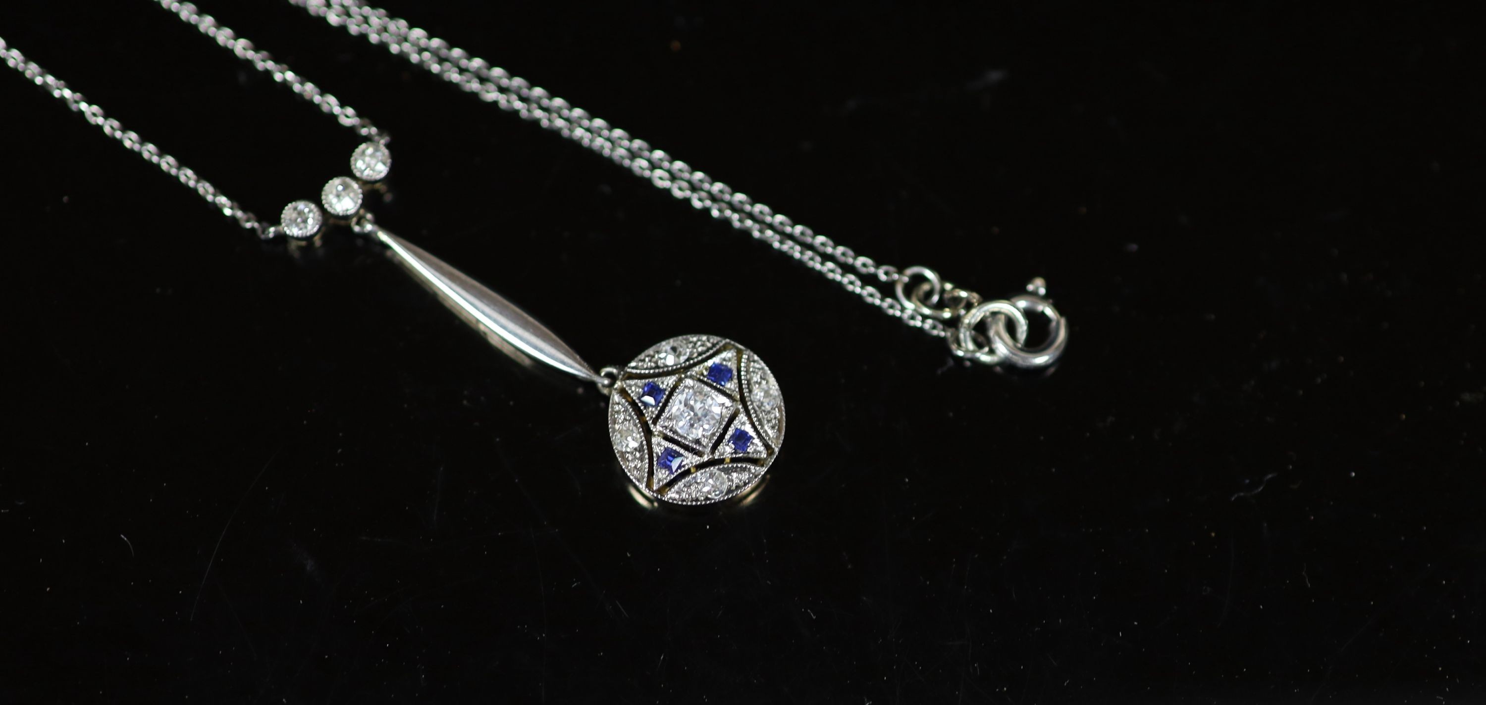 An Edwardian gold and platinum, millegrain set sapphire and diamond cluster set drop pendant necklace